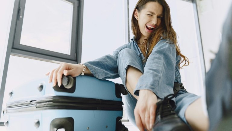 Happy traveler relaxing with luggage, representing stress-free and well-planned victory travel experience