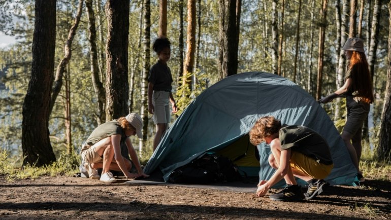 Teenagers enjoying outdoor adventure travel camp activities like hiking and cultural exploration in a safe and structured setting