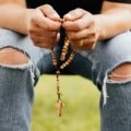 Traveler praying peacefully before starting a journey seeking protection and blessings