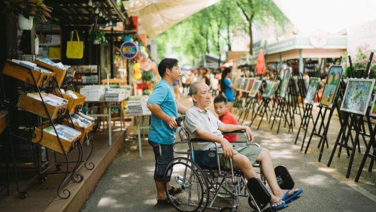 Traveler using lightweight foldable travel wheelchair for easy mobility on the go