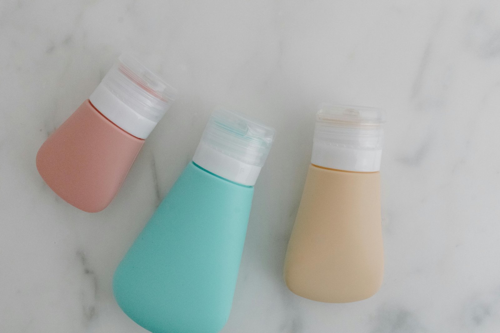 Travel size lotion bottles neatly packed in a toiletry bag, perfect for easy carry-on and skincare during travel