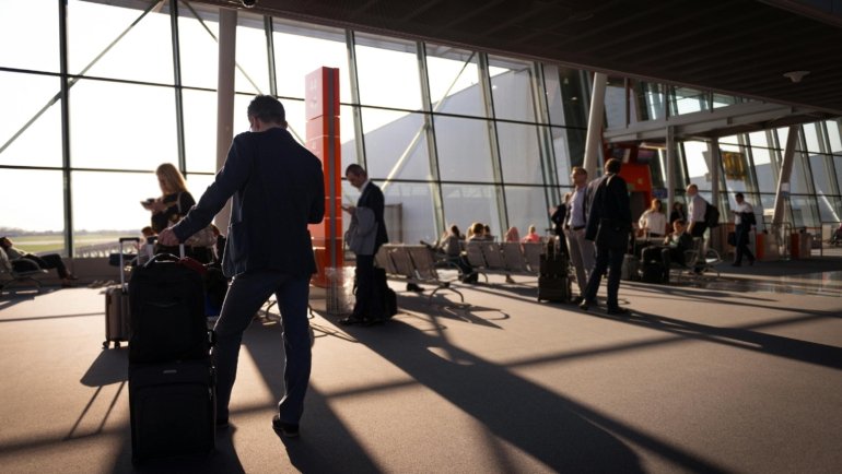 Traveler with suitcase at airport symbolizing global travel and journey