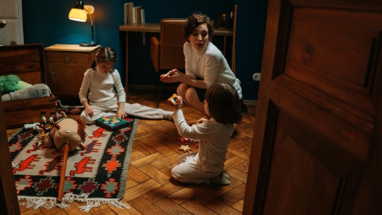 Travel nanny providing attentive childcare support to children during a family trip for stress-free travel experience