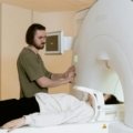 Traveling radiology technician operating medical imaging equipment in a hospital