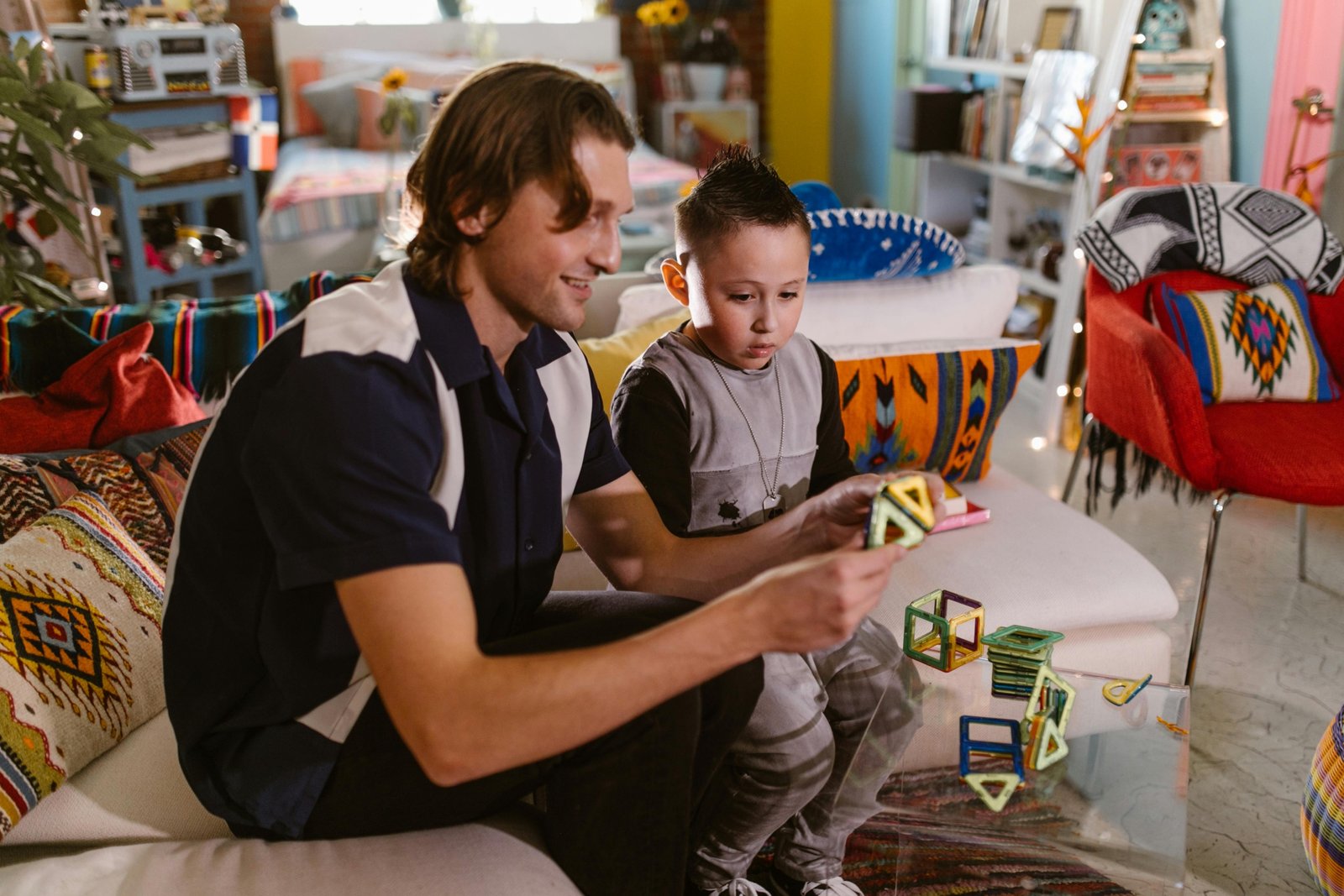 Children playing with colorful travel magnetic building tiles during a trip, showcasing portable educational toys for creative play