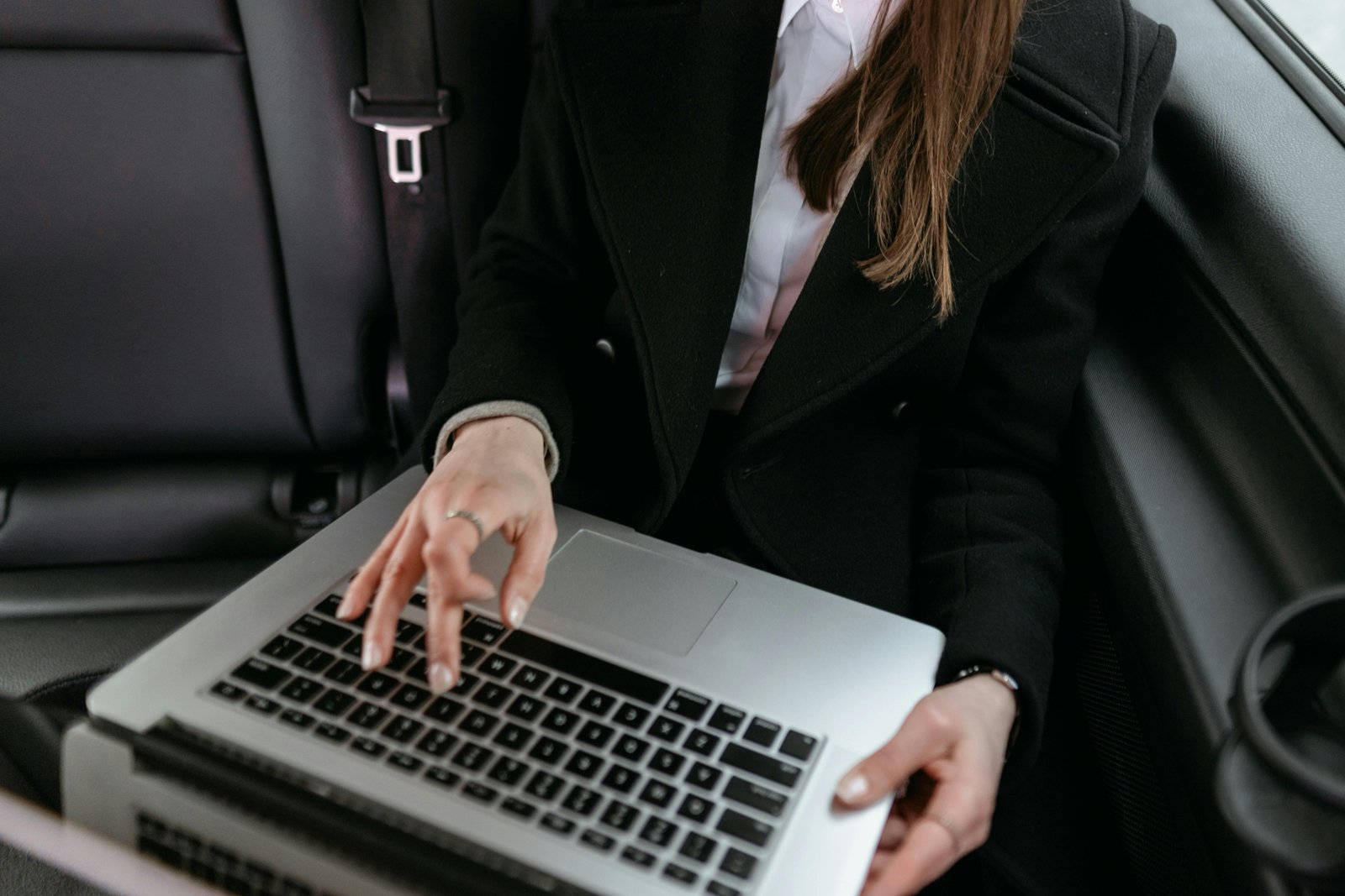 Certified Management Accountant working remotely on laptop while traveling for job assignments