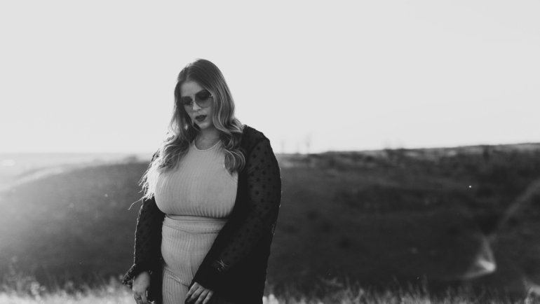 Plus size woman dressed in comfortable and stylish travel clothes enjoying her trip with confidence