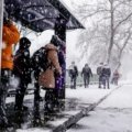 Winter snowstorm causing travel disruptions with snowy roads and cautious travelers during Thanksgiving holiday