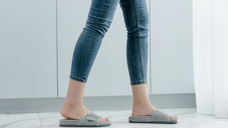 Aime Leon Dore travel slippers worn with casual outfit, showcasing stylish and comfortable footwear for travelers