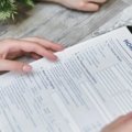 Person reviewing insurance policy documents highlighting the importance of insurance company verification and travelers NAIC number