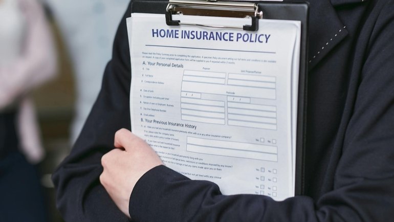 Traveler holding travel documents and insurance card for Spain trip safety and protection