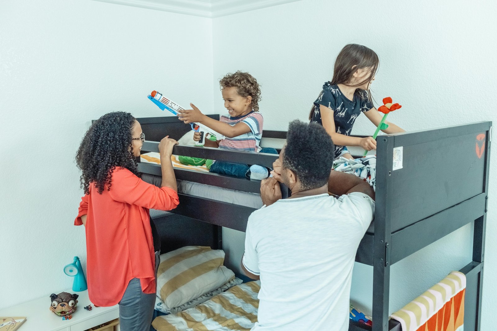 Interior of a family travel trailer with bunk beds showing children and parents enjoying a comfortable and practical road trip setup