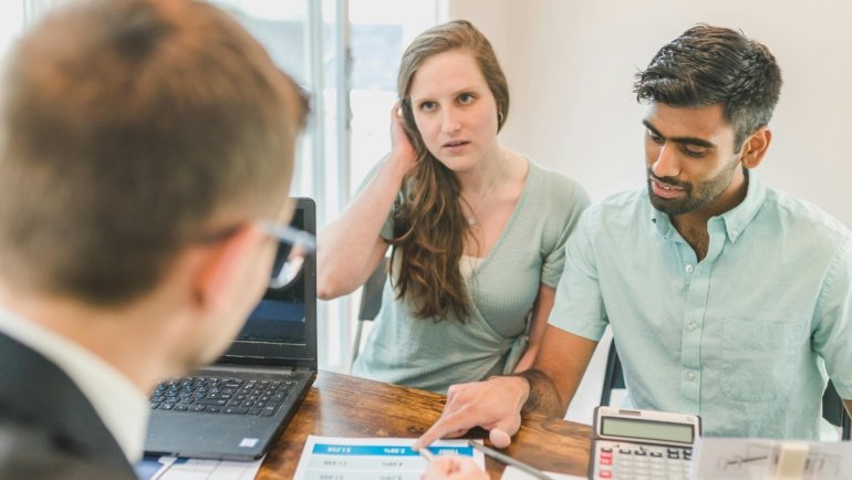 Travel agent assisting client with custom itinerary planning in San Antonio