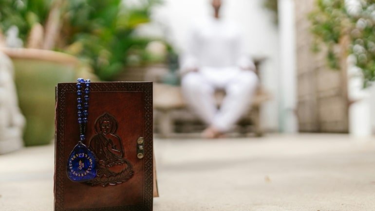 Traveler holding protective amulet symbolizing travel mercies and spiritual safety on journey