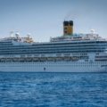 Modern cruise ship cruising smoothly through calm ocean waters under clear sky