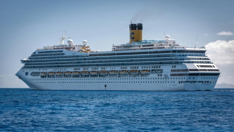 Modern cruise ship cruising smoothly through calm ocean waters under clear sky