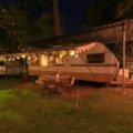 Cherokee travel trailer parked in nature with a family enjoying camping, showcasing comfort and versatile road trip living