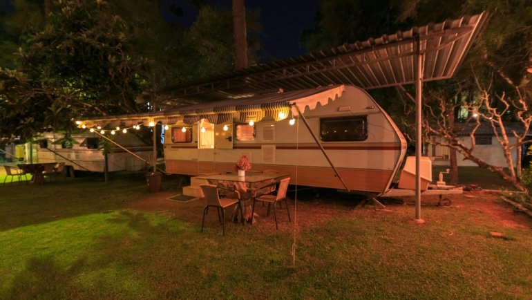 Cherokee travel trailer parked in nature with a family enjoying camping, showcasing comfort and versatile road trip living