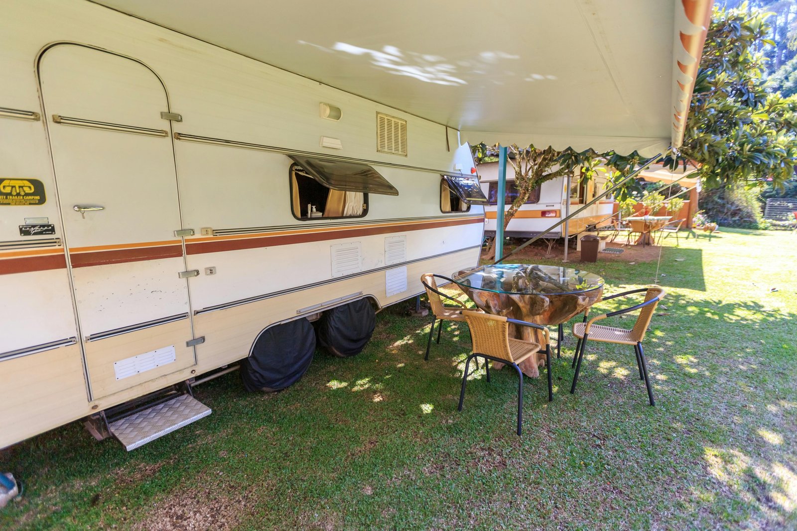 Travel trailer with electric awning extended creating a comfortable outdoor living space