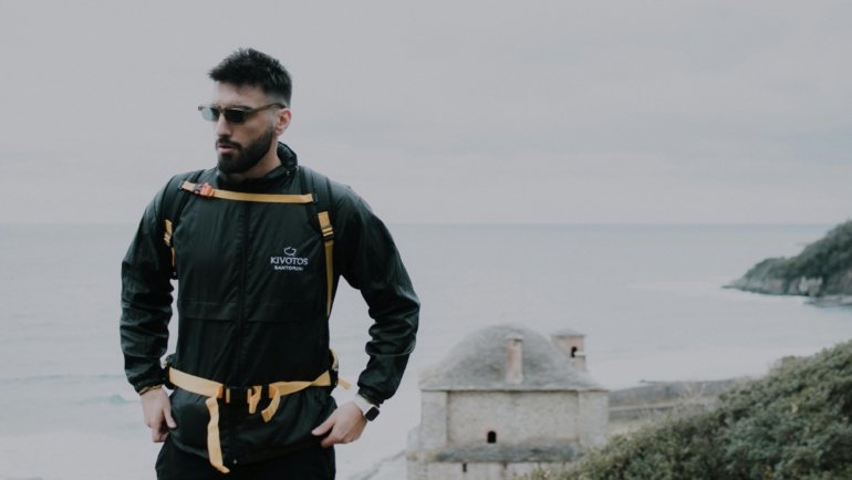 Traveler wearing a multifunctional baubax travel jacket with multiple pockets and accessories outside, ready for adventure