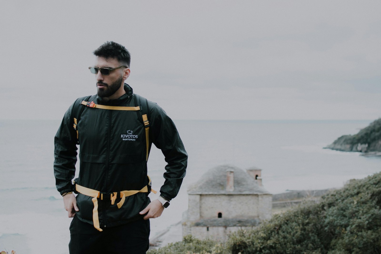 Traveler wearing a multifunctional baubax travel jacket with multiple pockets and accessories outside, ready for adventure