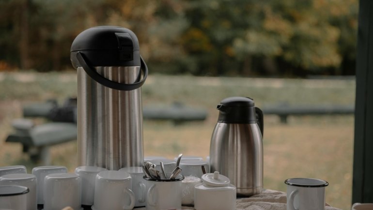 Starbucks coffee traveler large container with cups being shared by a group during a meeting or travel event