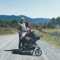 Parent pushing baby in safe and comfortable Chicco travel system stroller outdoors