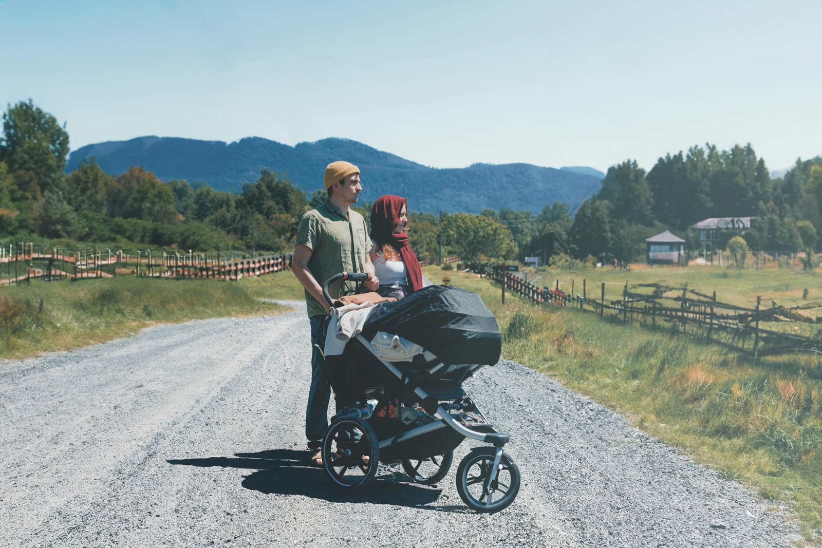 Parent pushing baby in safe and comfortable Chicco travel system stroller outdoors