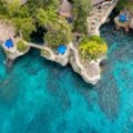 Luxury beachfront resort in Jamaica with private villas, clear turquoise ocean, and serene white sandy beach