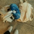 Traveler with a compact travel pillow bag attached to suitcase at airport for organized and comfortable journey