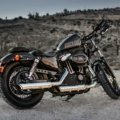 Durable water-resistant Harley Davidson motorcycle travel bag securely attached for long road trip