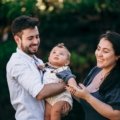 Family traveling with infant enjoying a peaceful outdoor setting during a family-friendly vacation