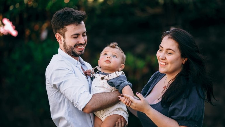 Family traveling with infant enjoying a peaceful outdoor setting during a family-friendly vacation