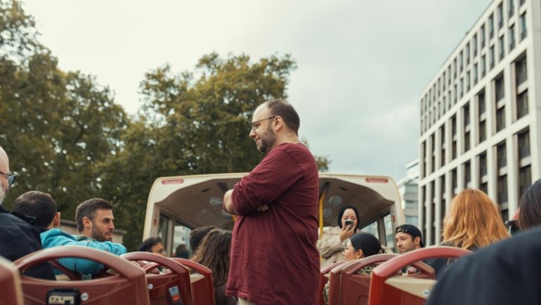 Group of happy travelers on a guided tour exploring popular travel destinations together