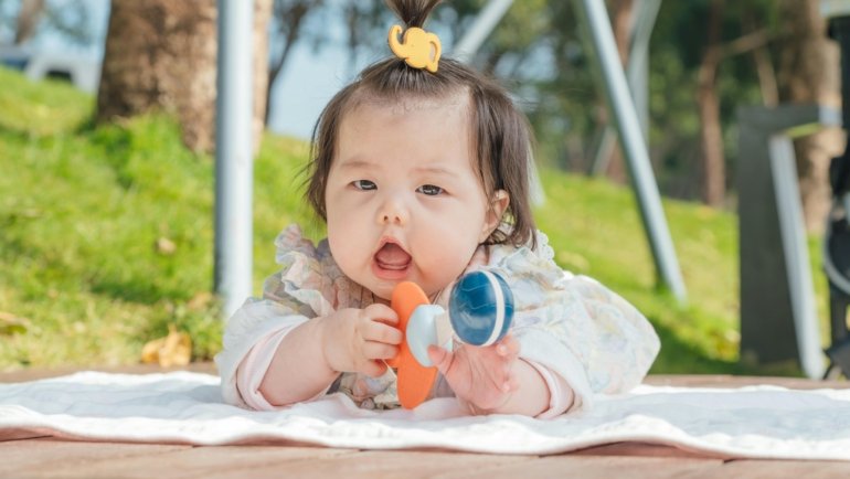 Lightweight portable baby playard for travel set up in a car trunk, showcasing convenience and safety for traveling families