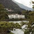 Beautiful springtime view of Lake Como with blooming gardens and calm blue waters under clear skies