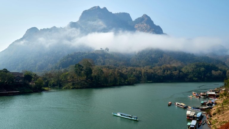 Scenic view of Laos landscape with ancient temples, lush nature, and cultural landmarks for travel package promotion