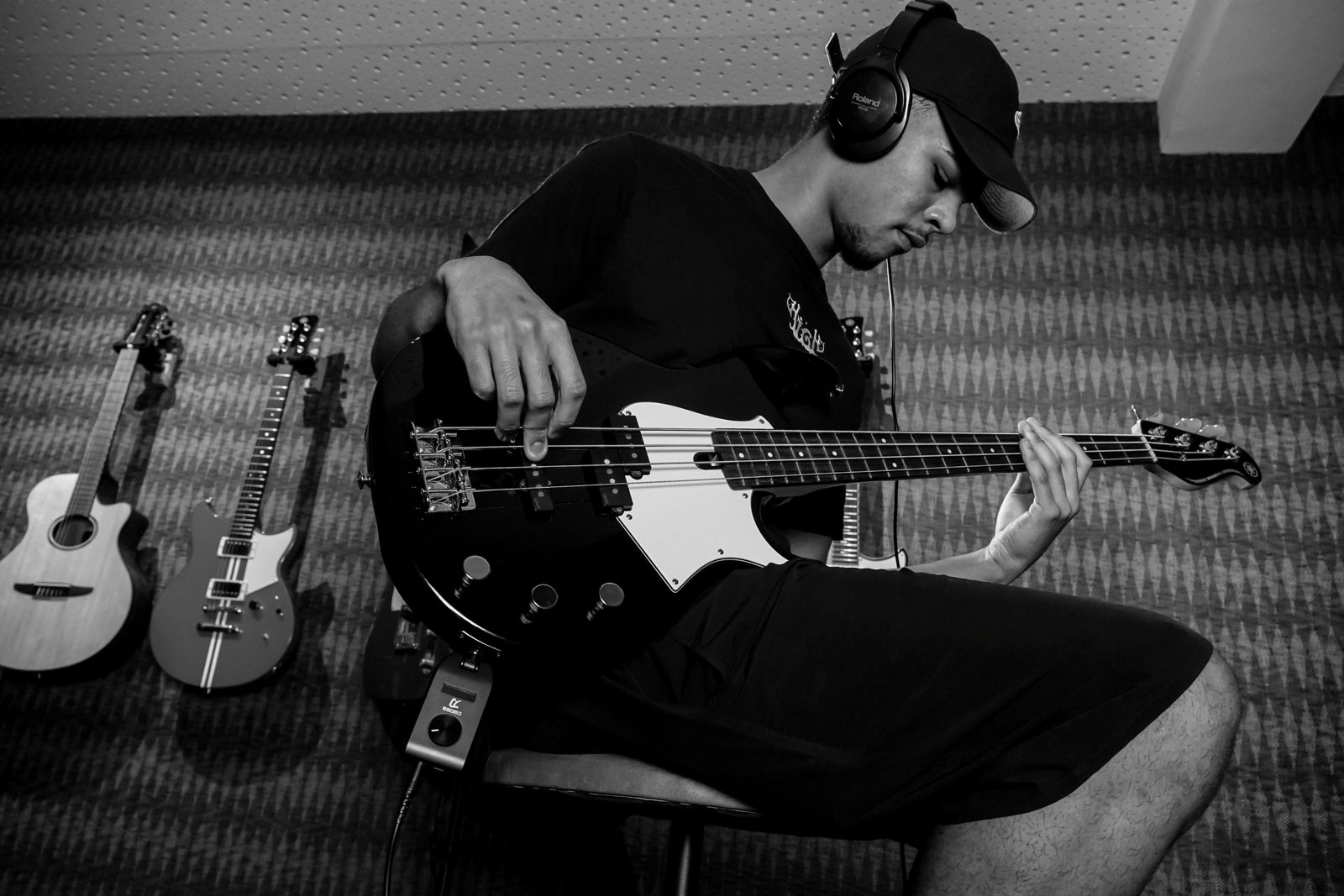 Bass player carrying a hard case bass guitar while traveling for music performances