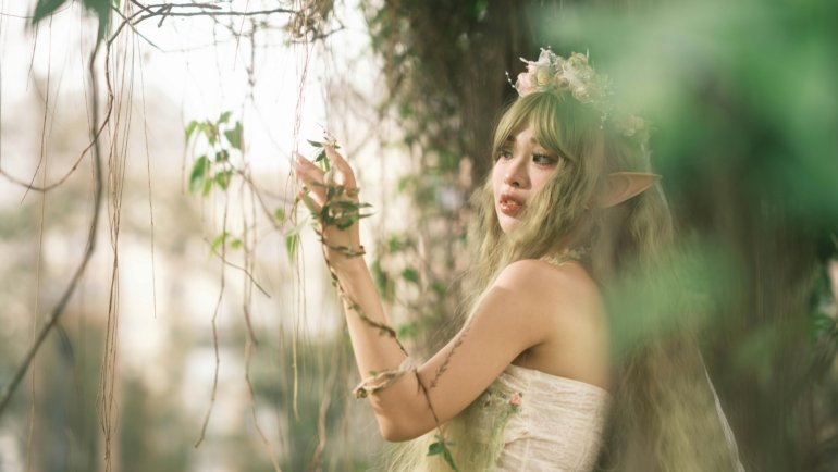 Fantasy female traveler using green dendro elemental magic in a lush magical forest