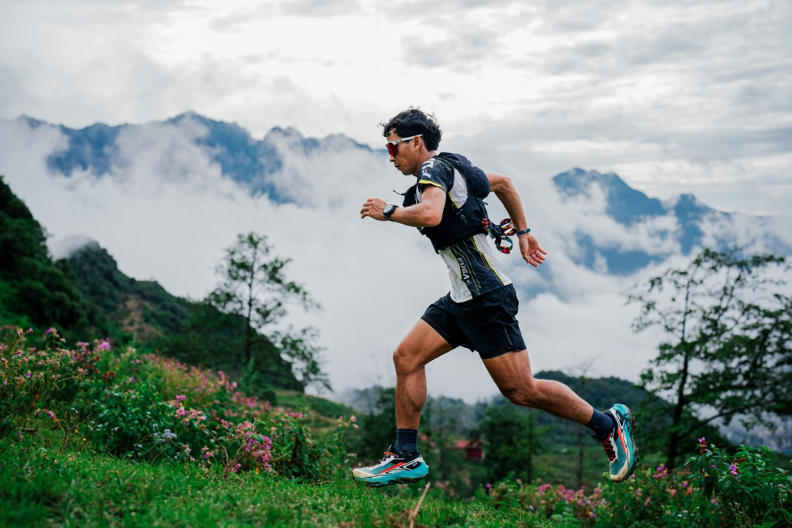 Ultramarathon runner on rocky mountain trail in forest during an endurance race