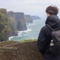 Solo traveler exploring scenic Irish coastline and countryside during a peaceful adventure in Ireland