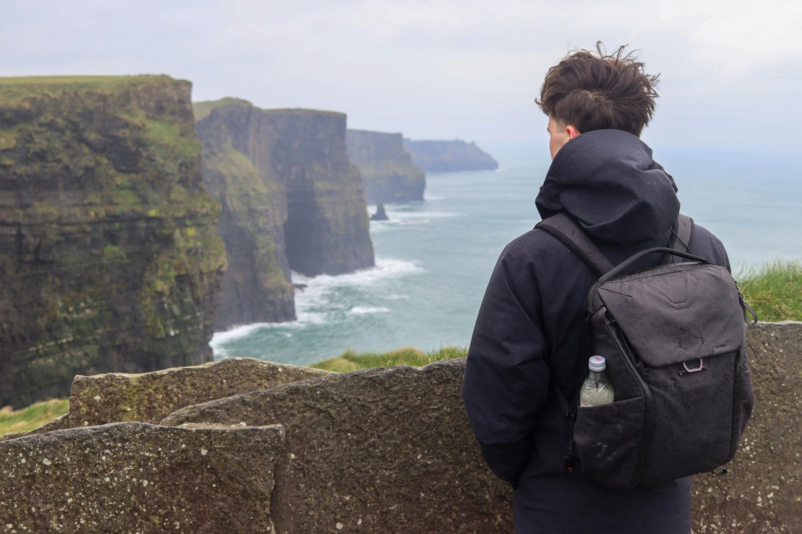 Solo traveler exploring scenic Irish coastline and countryside during a peaceful adventure in Ireland
