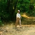 Woman wearing lightweight women's travel pants hiking outdoors, comfortable and stylish for travel