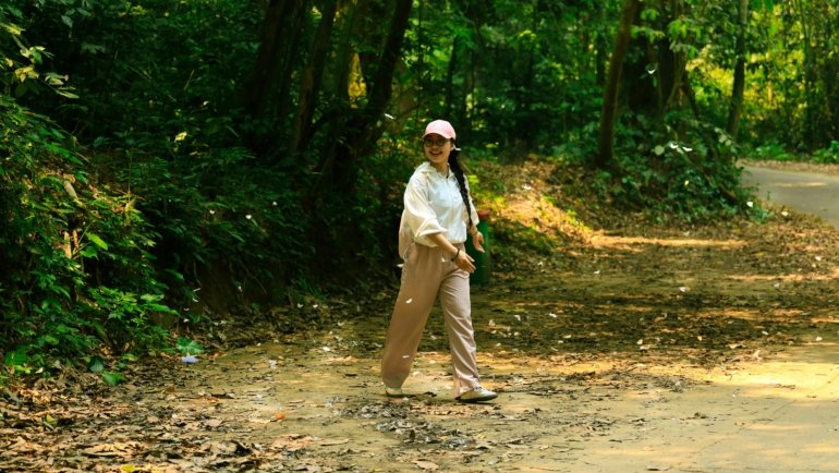 Woman wearing lightweight women's travel pants hiking outdoors, comfortable and stylish for travel