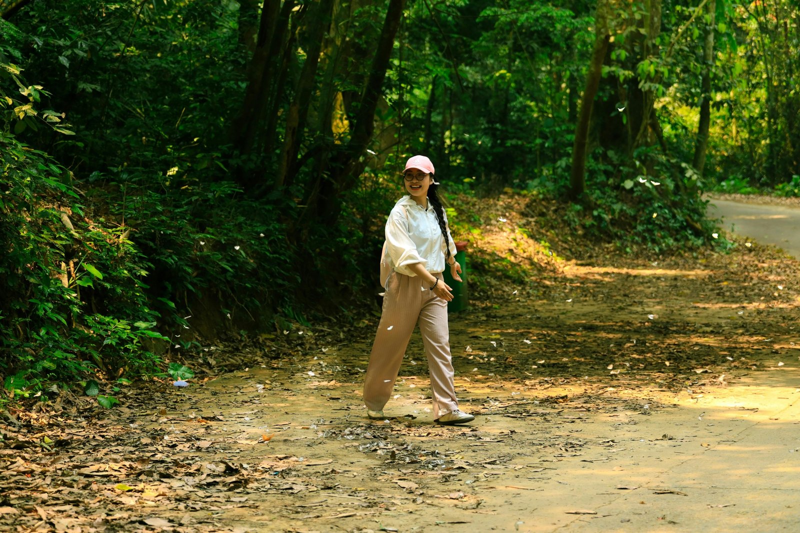 Woman wearing lightweight women's travel pants hiking outdoors, comfortable and stylish for travel