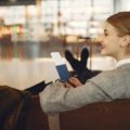 Smiling traveler enjoying a funny moment at the airport, embodying travel humor and positive travel experiences