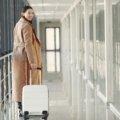 Happy traveler walking confidently through airport with organized suitcase representing easy and stress-free travel