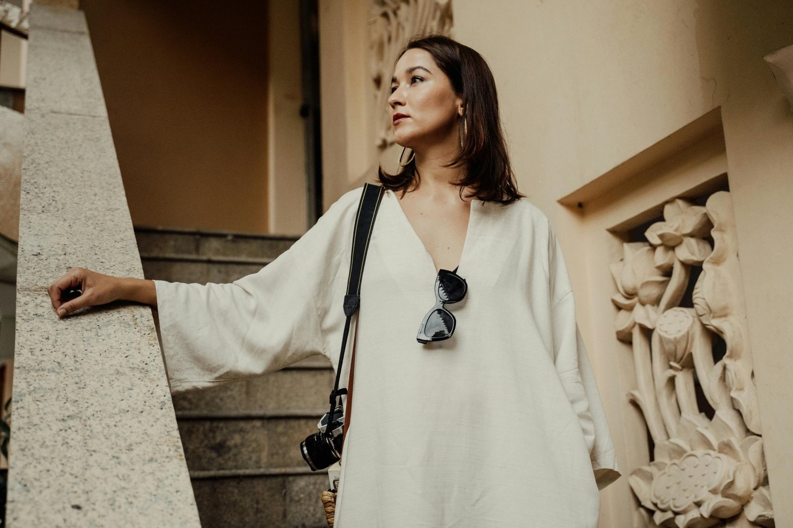 Petite woman wearing a tailored travel outfit with layering, comfortable shoes, and accessories, ready for a stylish and practical trip