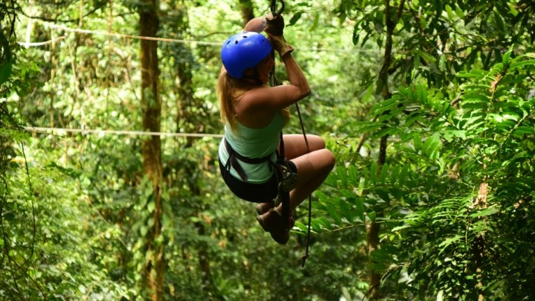 Solo traveler exploring lush rainforest in Costa Rica enjoying adventure and nature