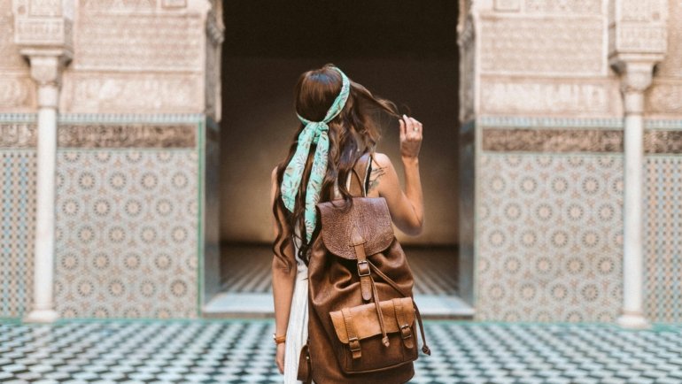 Female solo traveler exploring a vibrant city street embracing local culture and lifestyle